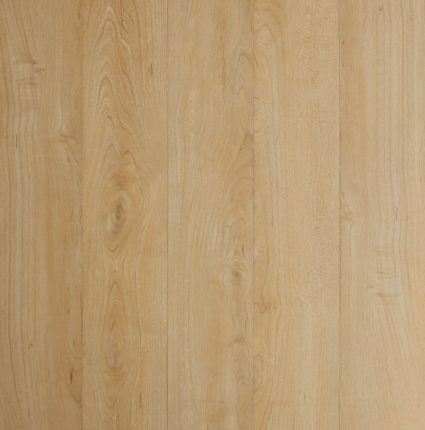 Light natural wood plank surface with visible grain and subtle vertical seams between boards.