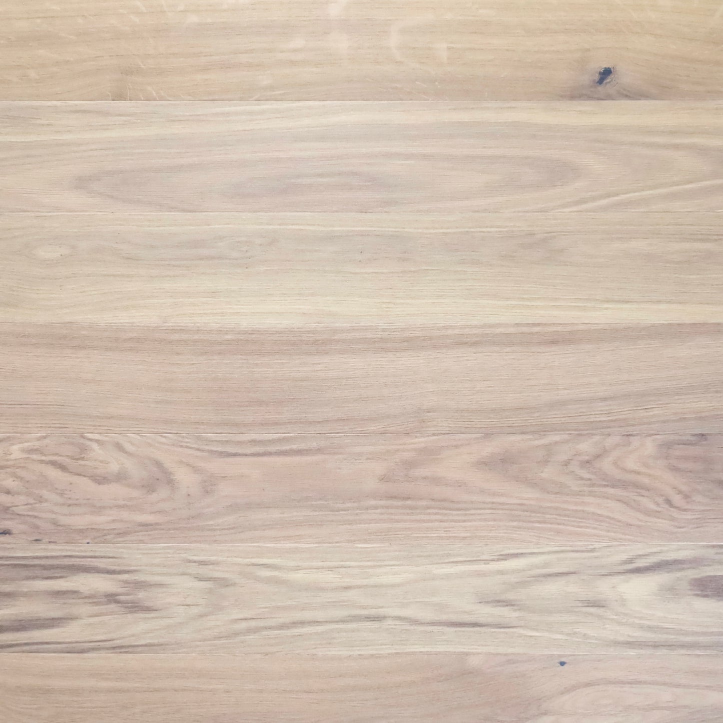 Close-up of a wooden surface with a light brown color and visible grain pattern.