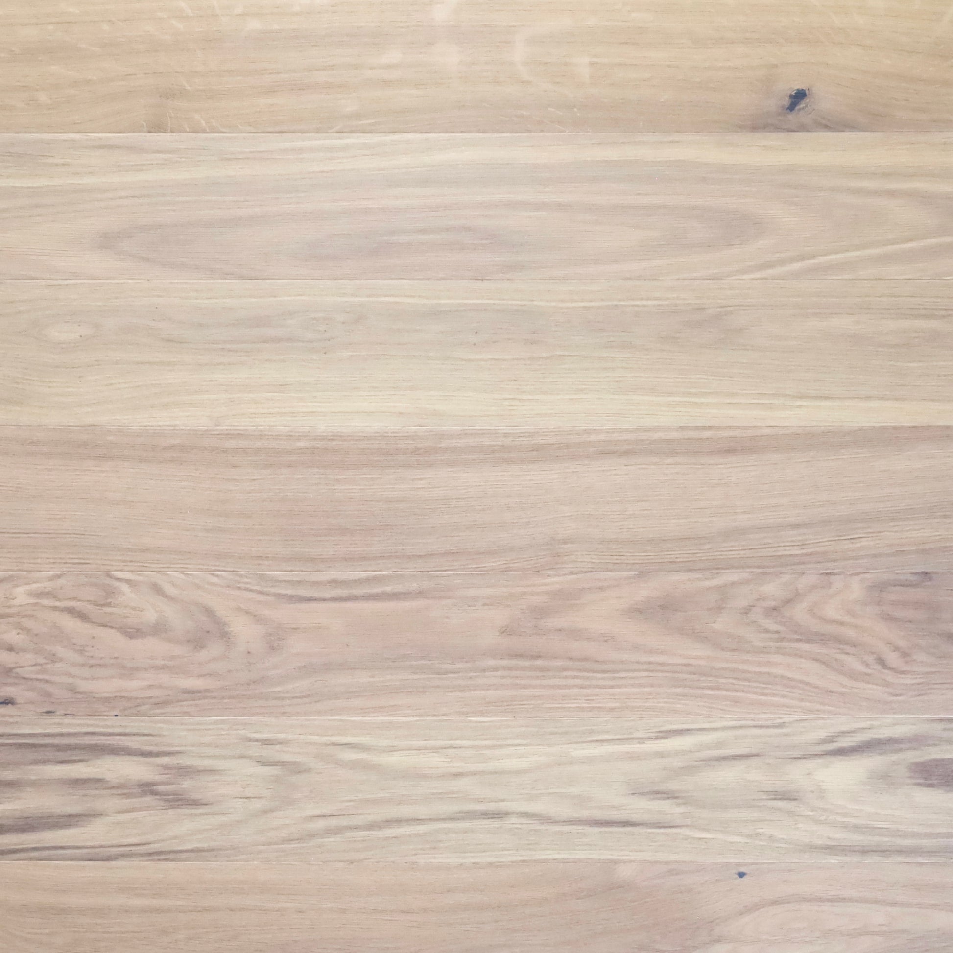 Close-up of a wooden surface with a light brown color and visible grain pattern.