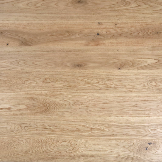 Close-up of a wooden surface with a light brown color and visible grain pattern.