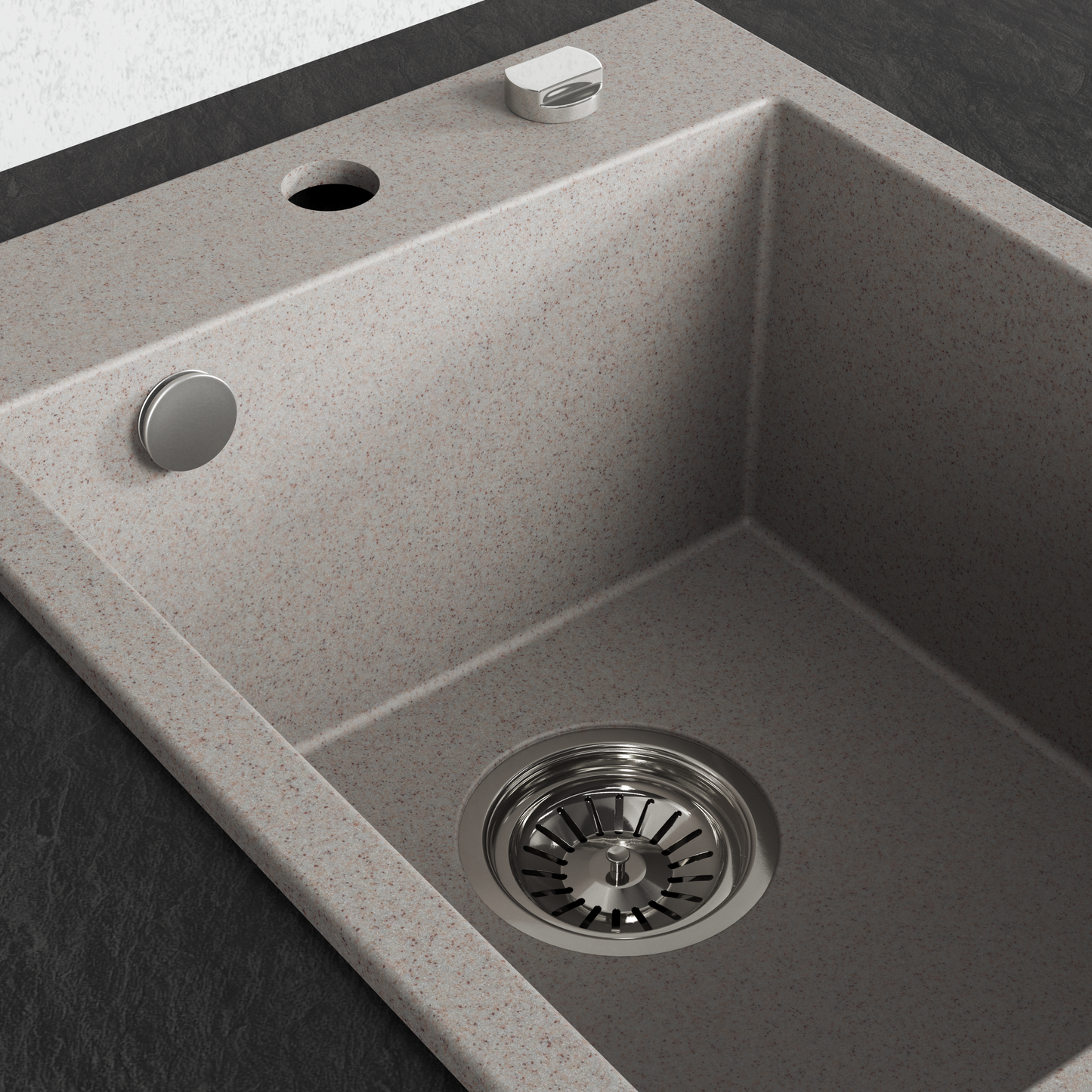 A single-basin drop-in kitchen sink made of speckled beige beach sand, stone or composite material, shown installed on a dark countertop with a matching faucet and drain visible.